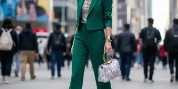 Woman showcasing 2026 accessory trends with statement necklace and stylish handbag